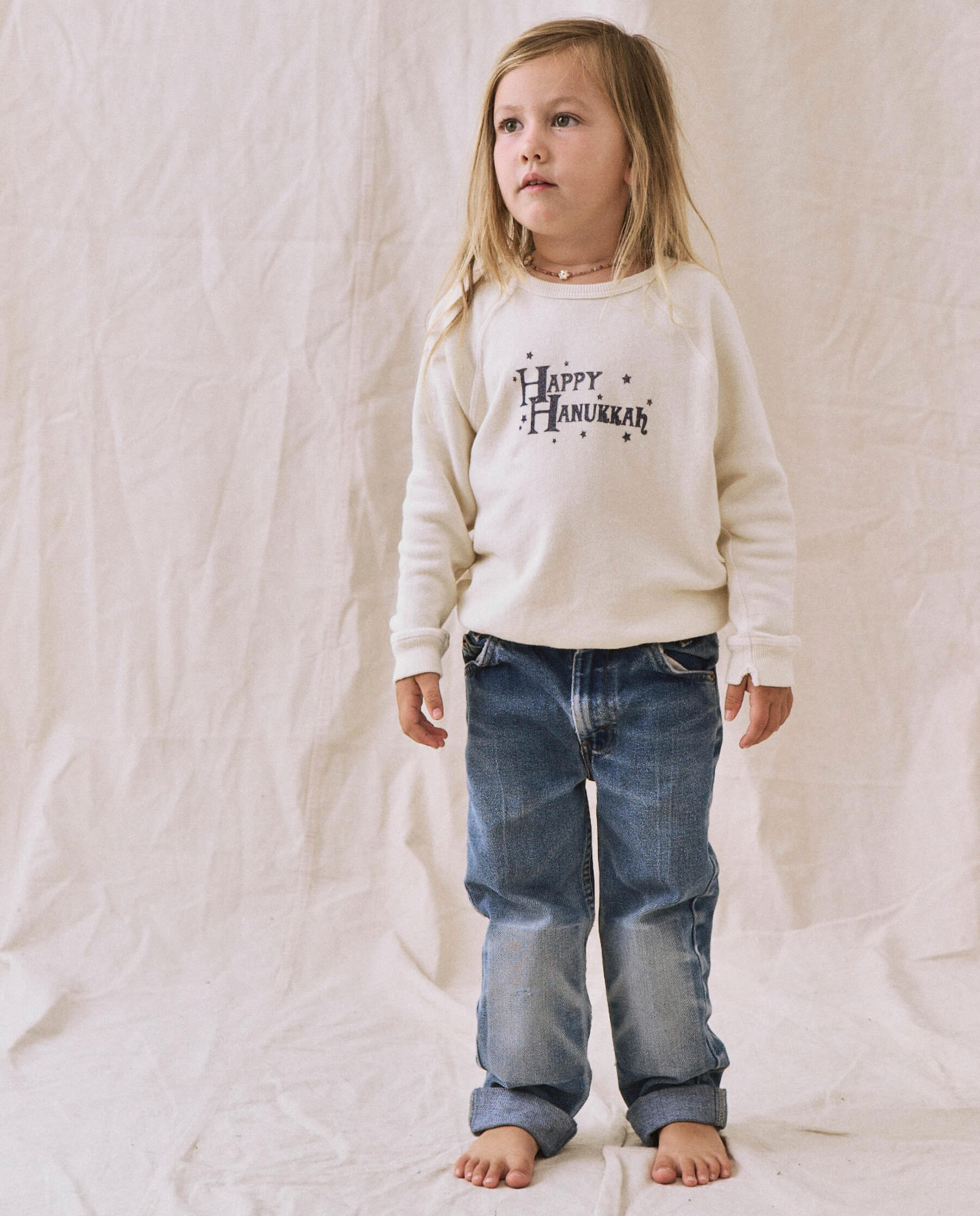 The Little College Sweatshirt. -- Washed White with Hanukkah Graphic