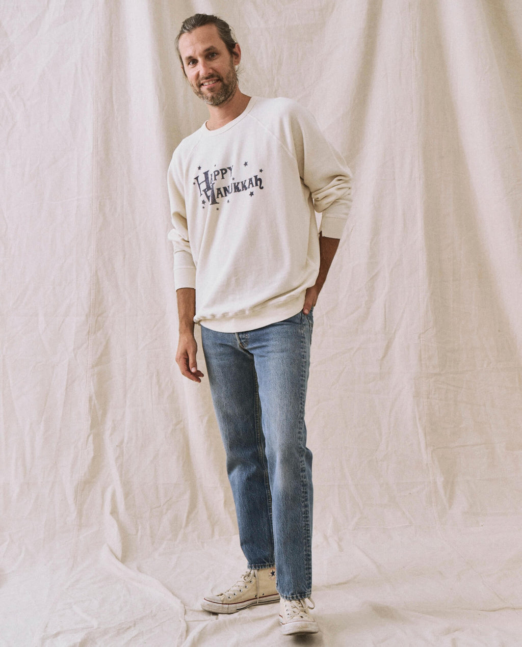 The Men's College Sweatshirt. -- Washed White with Hanukkah Graphic