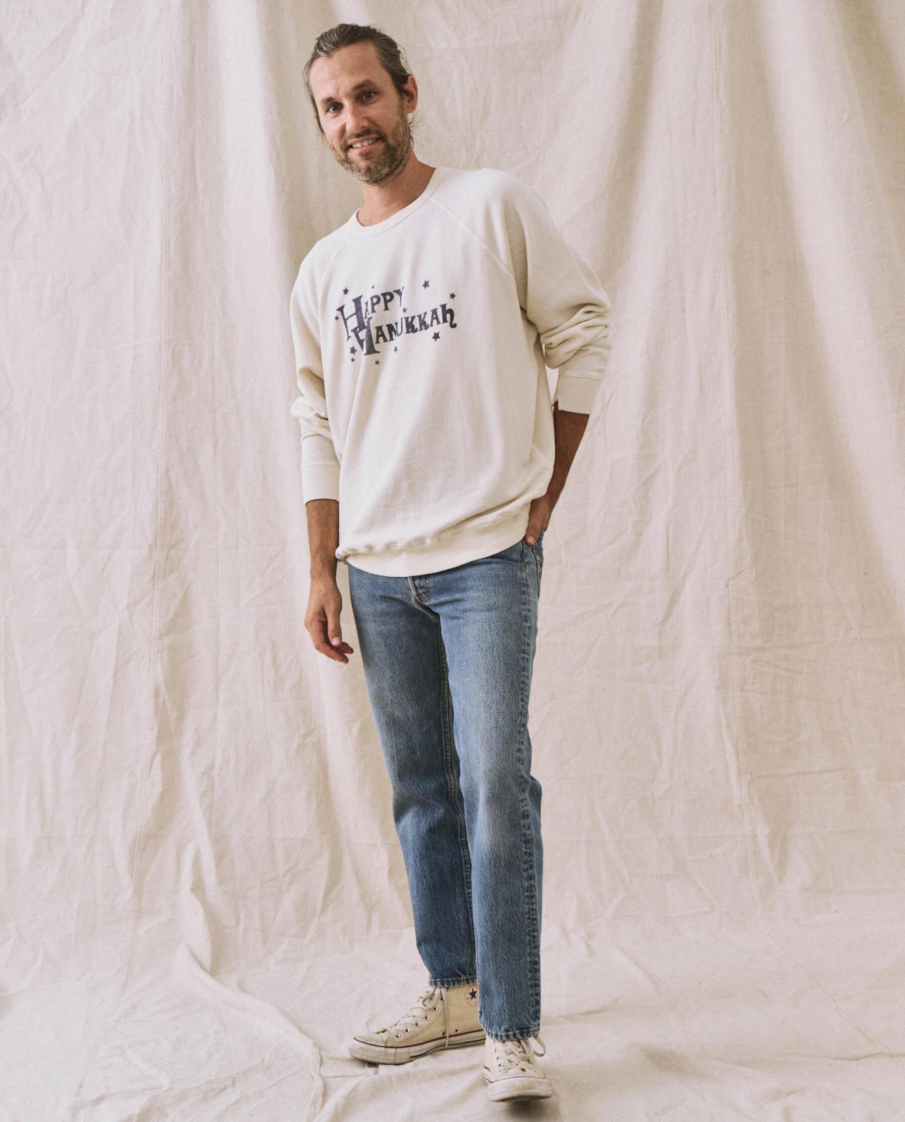 The Men's College Sweatshirt. -- Washed White with Hanukkah Graphic