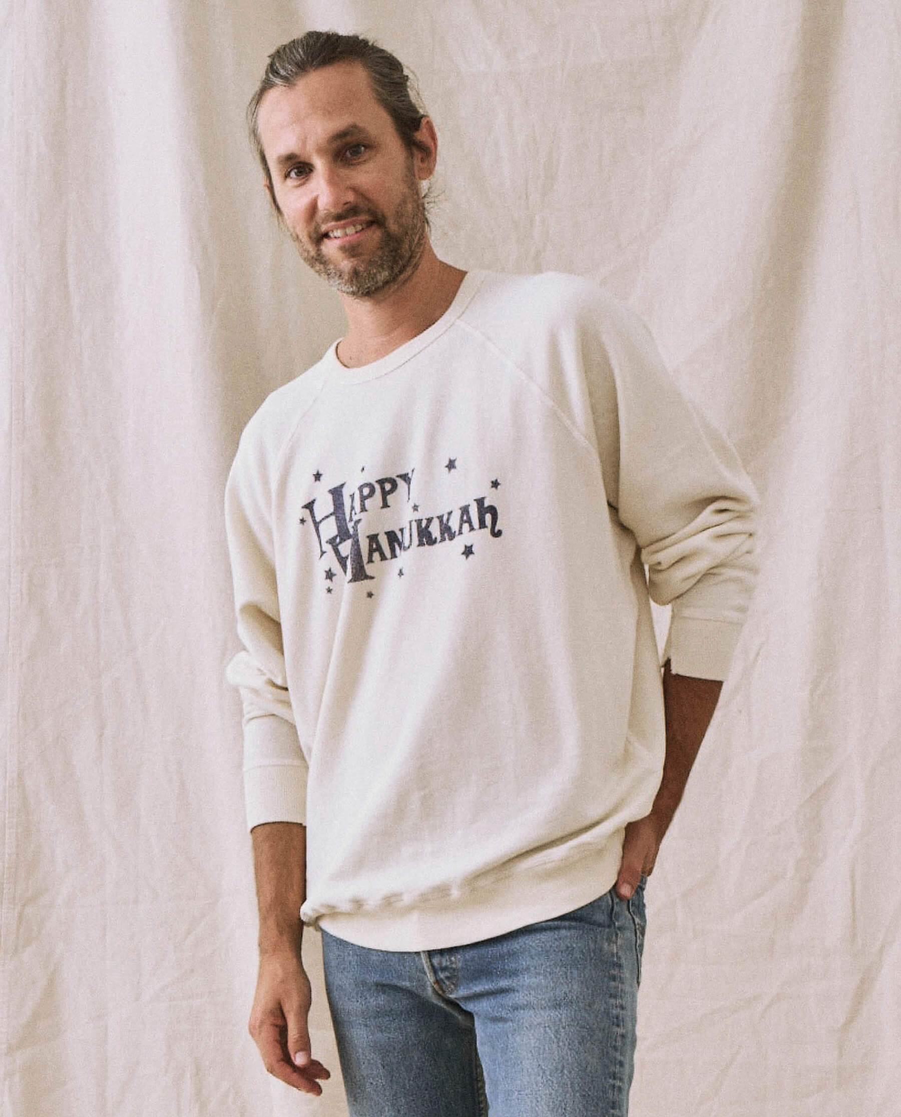 The Men's College Sweatshirt. -- Washed White with Hanukkah Graphic