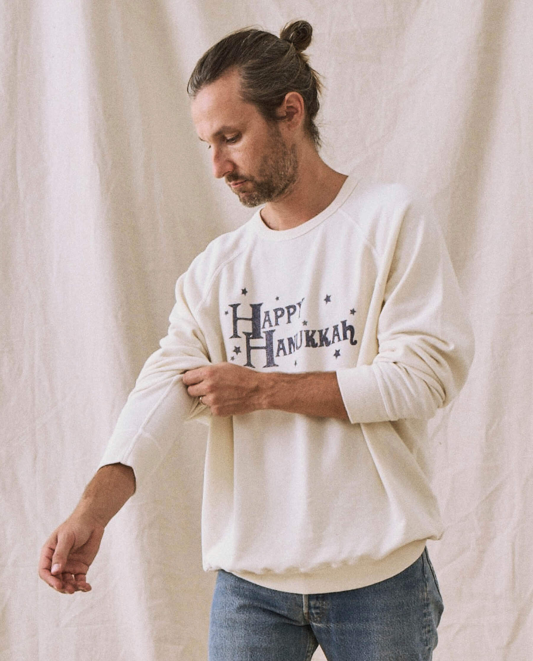 The Men's College Sweatshirt. -- Washed White with Hanukkah Graphic