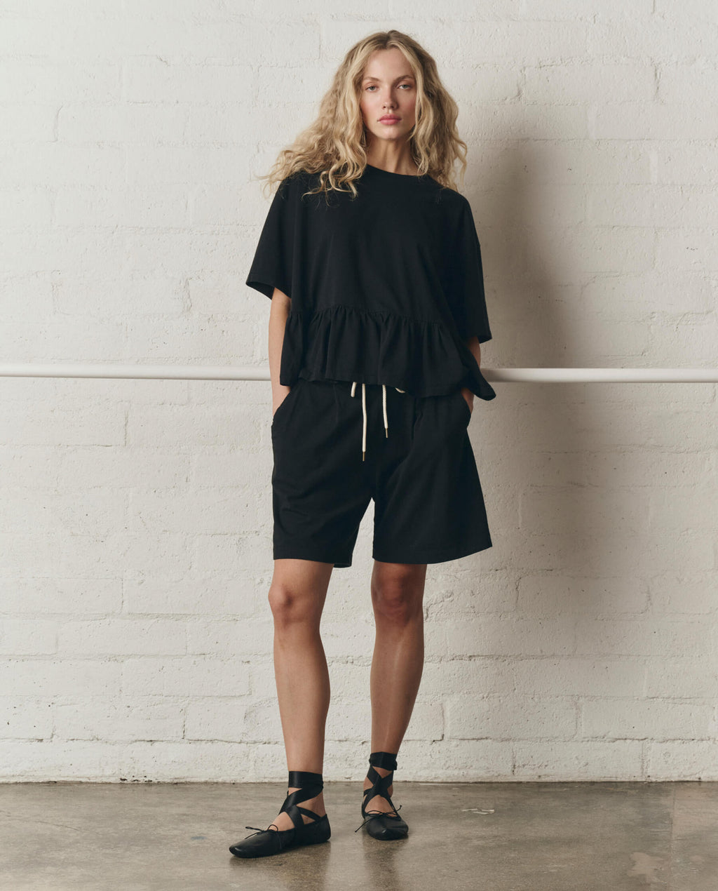 The Oversized Ruffle Peplum Tee. -- True Black