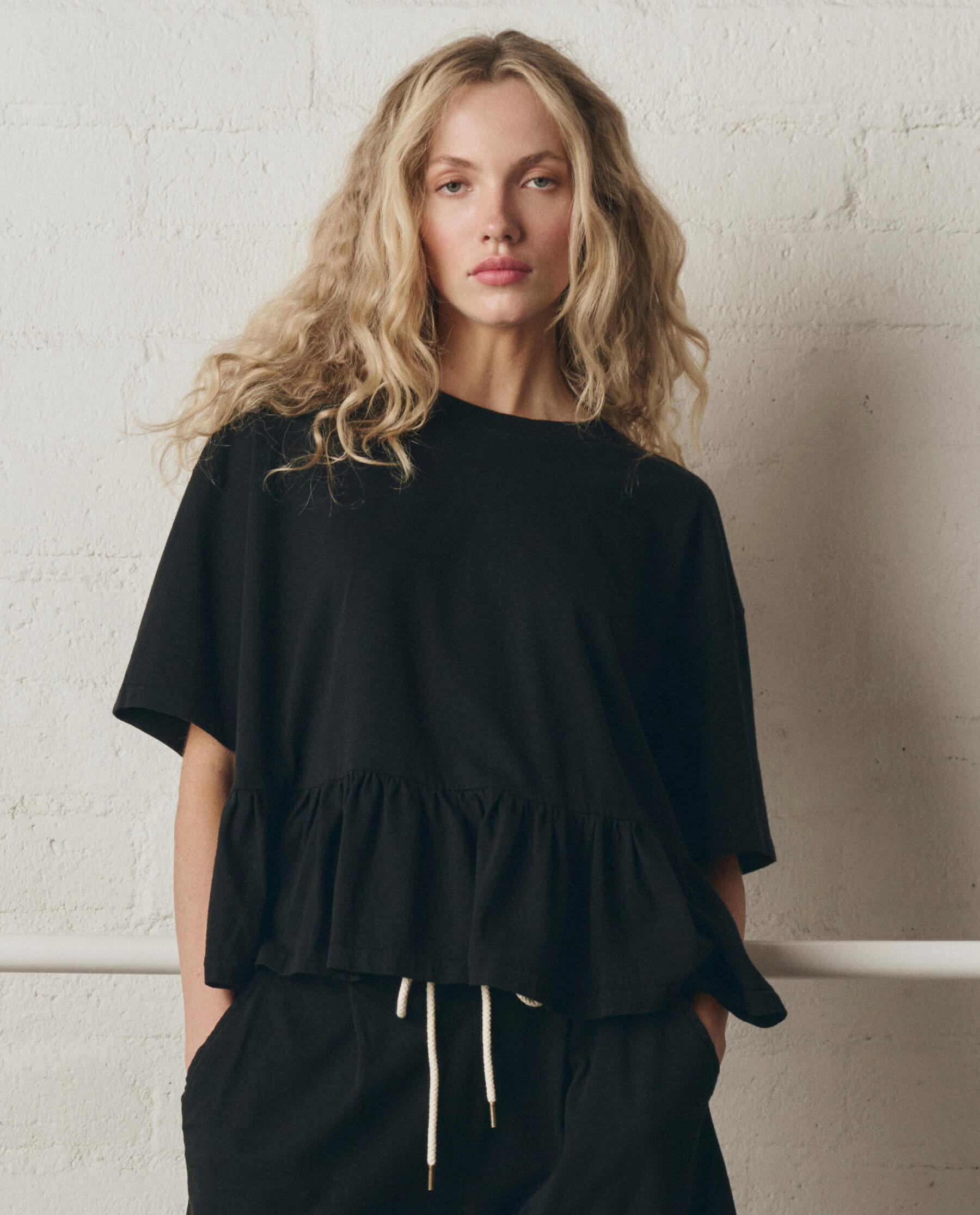The Oversized Ruffle Peplum Tee. -- True Black