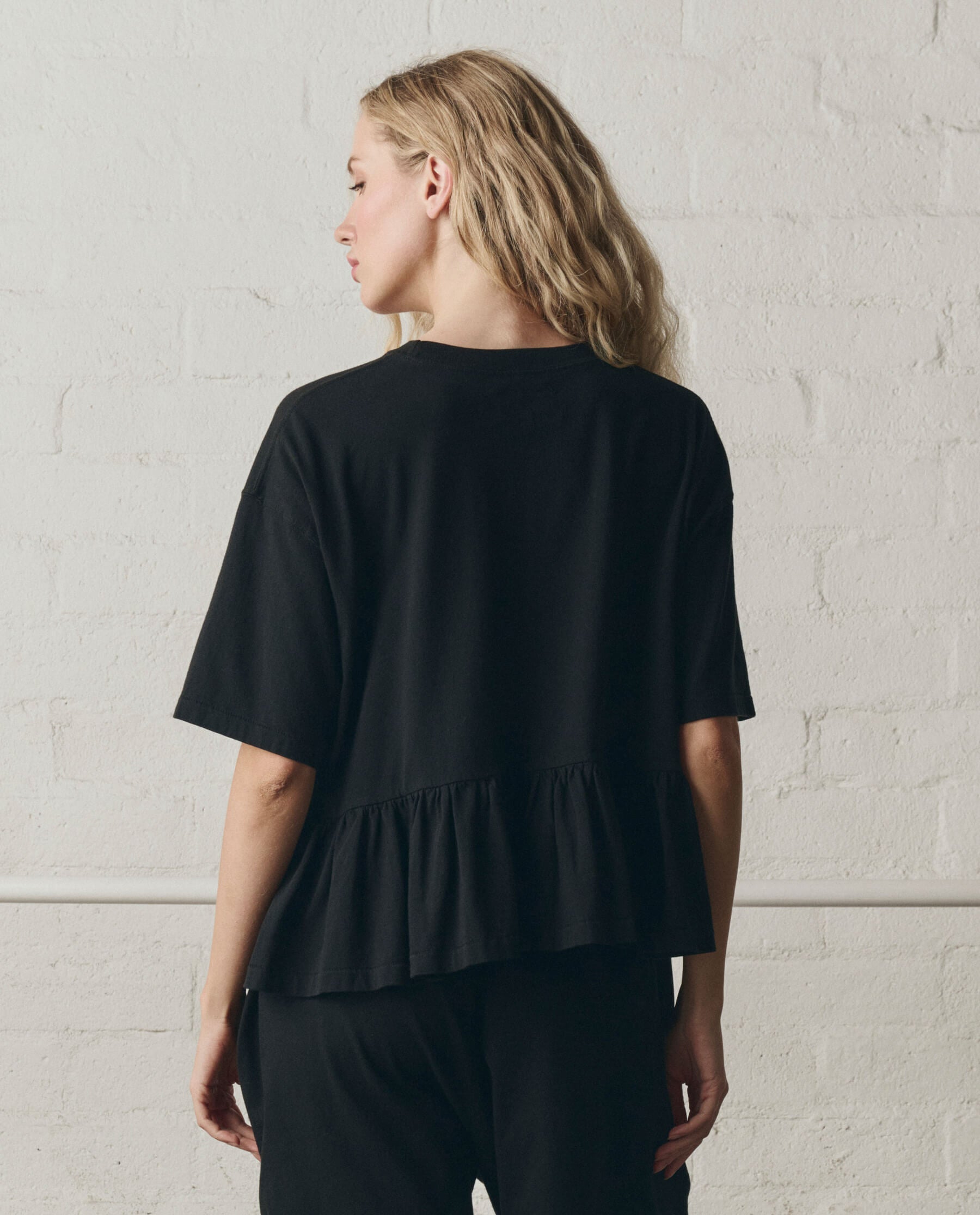 The Oversized Ruffle Peplum Tee. -- True Black